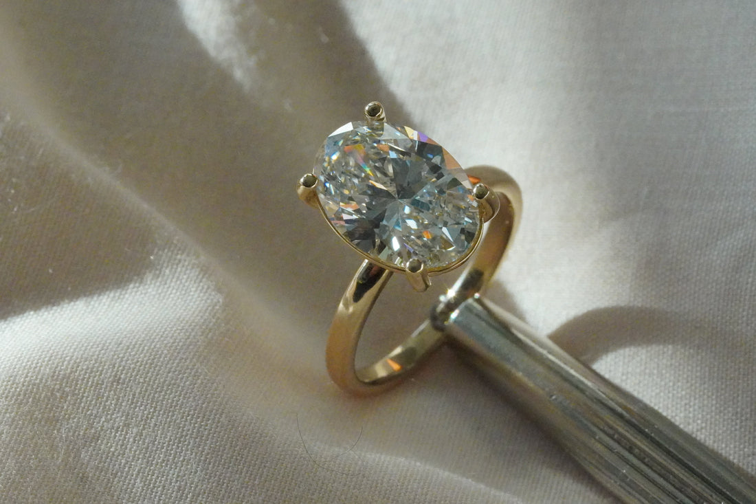 A secret ring-sizing kit and a beautiful diamond ring from Jacob Mark Jewelers, the best custom jewelers in Fort Worth.