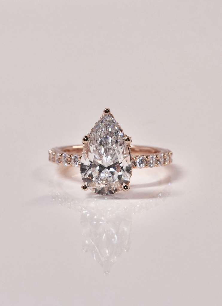 pear shaped diamond engagement ring rose gold band close up